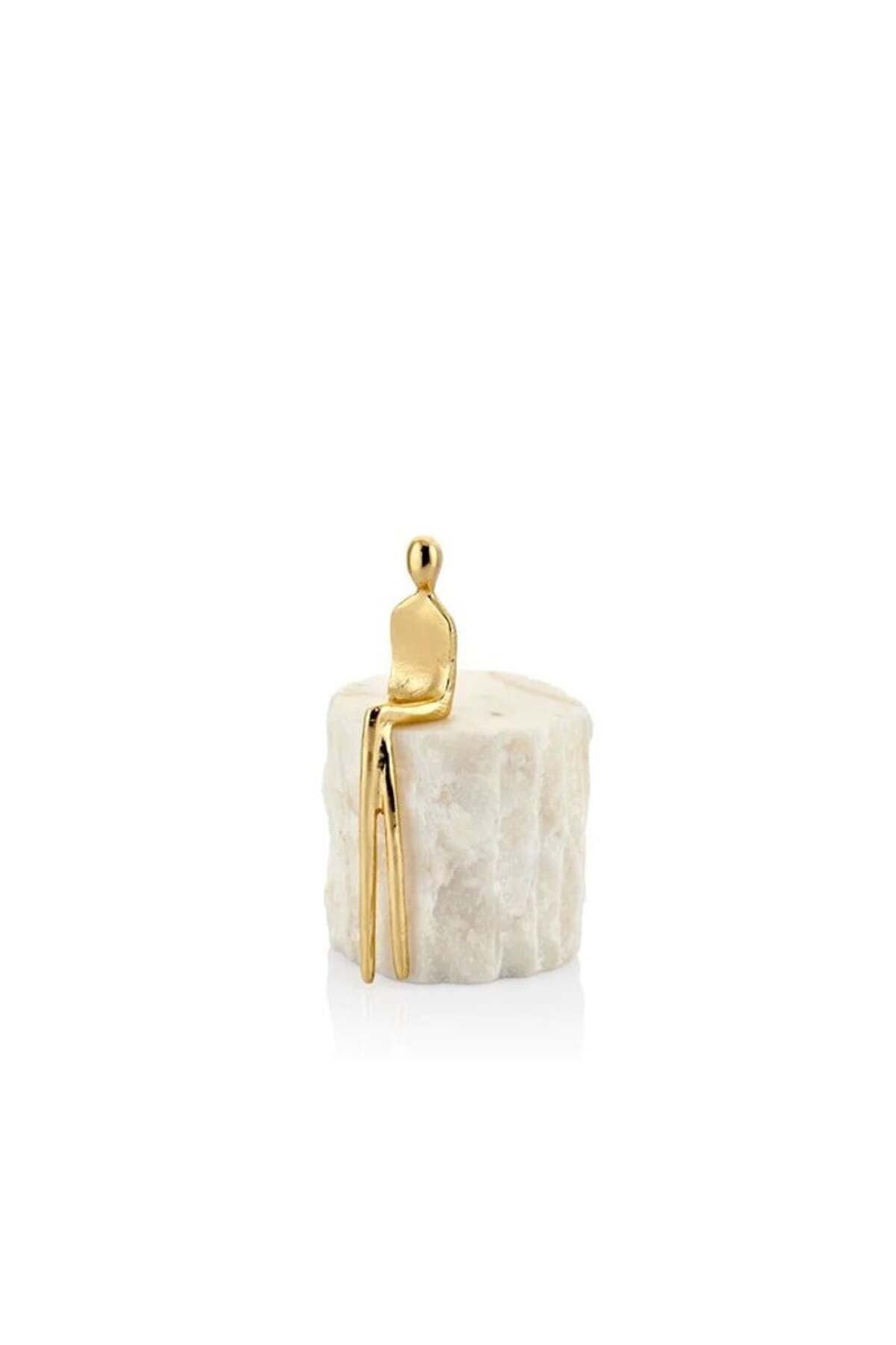 Seated gold figure on white marble, small